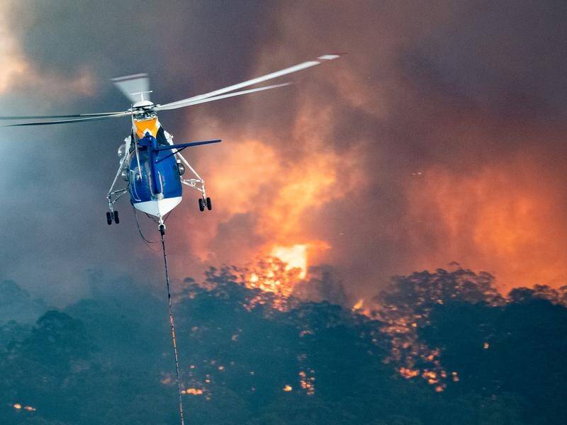 A helicopter tackles a bushfire in Victoria's East Gippsland region during the Black Summer blazes. (HANDOUT/STATE GOVERNMENT OF VICTORIA)