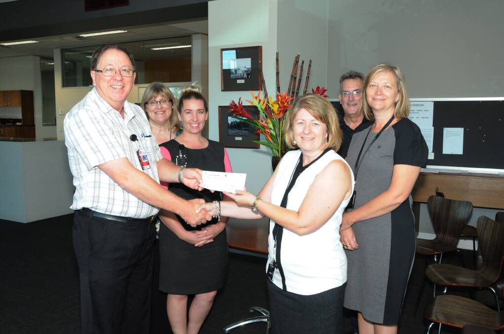 Peter Woodward from Dubbo Hospital receives a cheque from Dubbo City Council s Organisational Services division representative Susan Wade. Also present are Kerrilyn Oriel, Emma Meek, Ross West and Steph O Dell from Organisational Services.  
Photo: HANNAH SOOLE