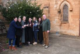 Catholic Ball committee members Claire Bynon, Bibiana Lappa, Jo Trimboli, Monique Donoghue, Brooke Winterton and Petrina Dowton with Father Greg Kennedy in front of St Brigid's Hall. Picture by Orlander Ruming